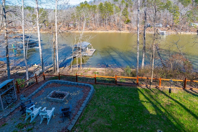 view of yard with a fire pit and a water view