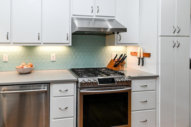 kitchen featuring backsplash, white cabinetry, wall chimney exhaust hood, and appliances with stainless steel finishes