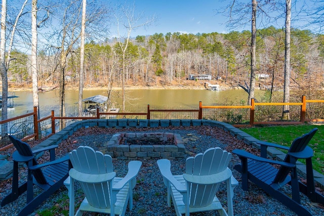 view of patio / terrace with a water view and a fire pit