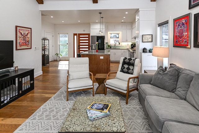 living room featuring sink, dark hardwood / wood-style flooring, and a notable chandelier