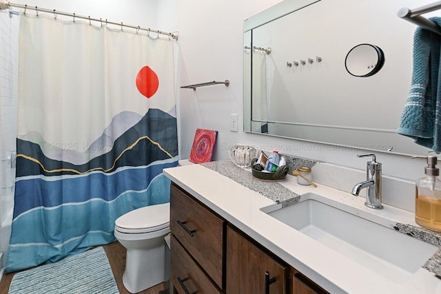 bathroom featuring hardwood / wood-style floors, vanity, curtained shower, and toilet