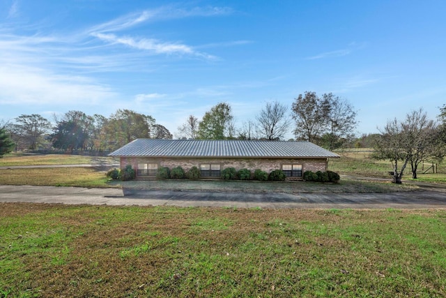 view of community featuring a lawn and a rural view