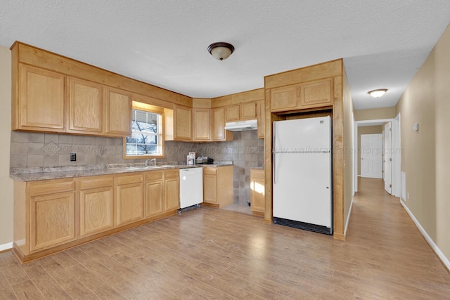 kitchen with light brown cabinetry, light wood-type flooring, backsplash, white appliances, and sink