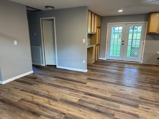 spare room with french doors and dark wood-type flooring