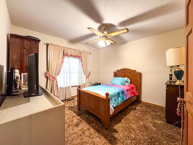 carpeted bedroom featuring ceiling fan and a textured ceiling