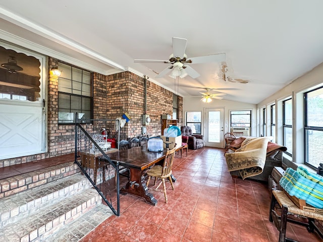 sunroom featuring lofted ceiling and ceiling fan