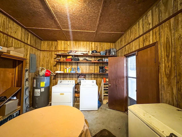 washroom with water heater, separate washer and dryer, electric panel, and wooden walls