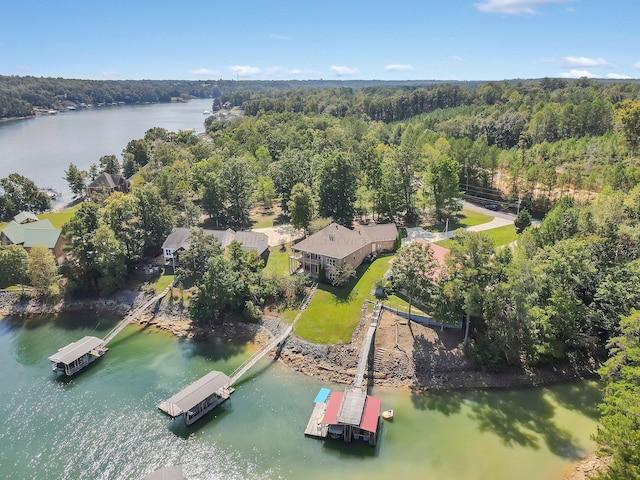 birds eye view of property featuring a wooded view and a water view