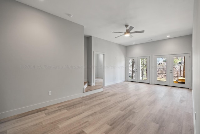 spare room featuring french doors, light hardwood / wood-style flooring, and ceiling fan