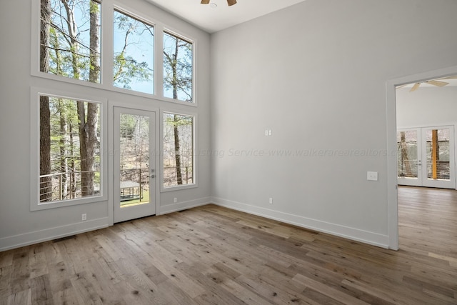 interior space featuring plenty of natural light, ceiling fan, and wood-type flooring