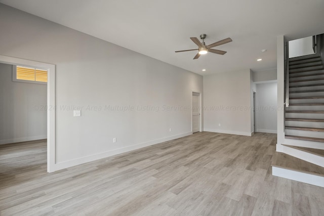 unfurnished living room featuring ceiling fan and light wood-type flooring