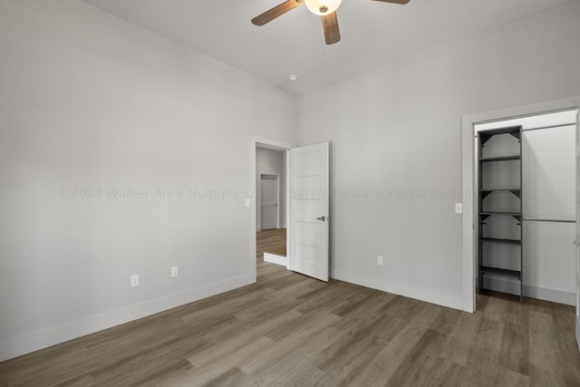 unfurnished bedroom featuring ceiling fan and hardwood / wood-style flooring