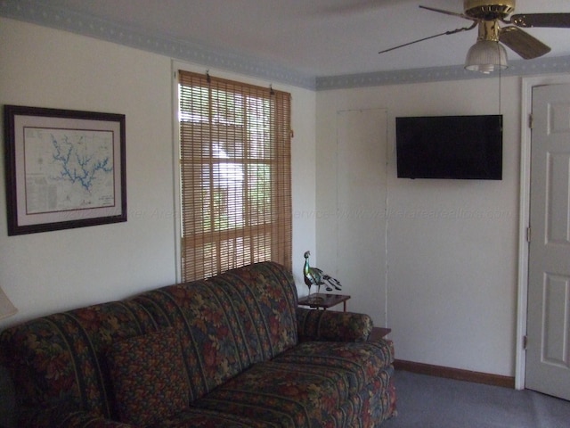 living area with baseboards, a ceiling fan, and carpet floors