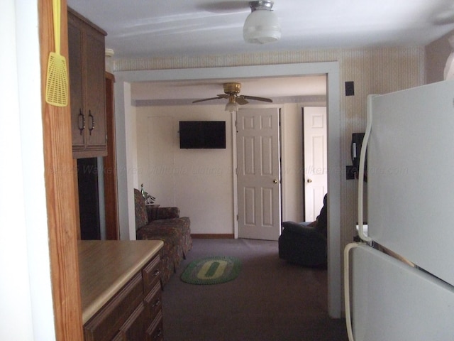 kitchen with freestanding refrigerator, carpet floors, wallpapered walls, ceiling fan, and light countertops