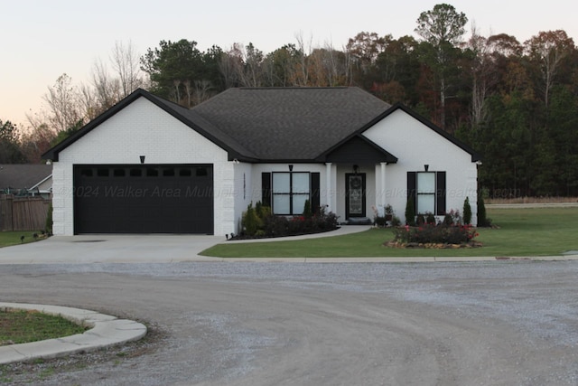 view of front facade with a garage and a yard