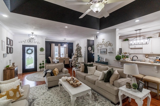 living room featuring ceiling fan, light wood-type flooring, and ornamental molding