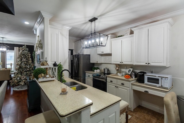 kitchen featuring white cabinetry, sink, dark hardwood / wood-style floors, decorative light fixtures, and appliances with stainless steel finishes