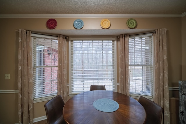 dining room with ornamental molding and a textured ceiling