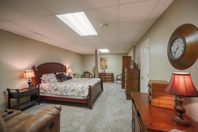 bedroom featuring a paneled ceiling and light colored carpet