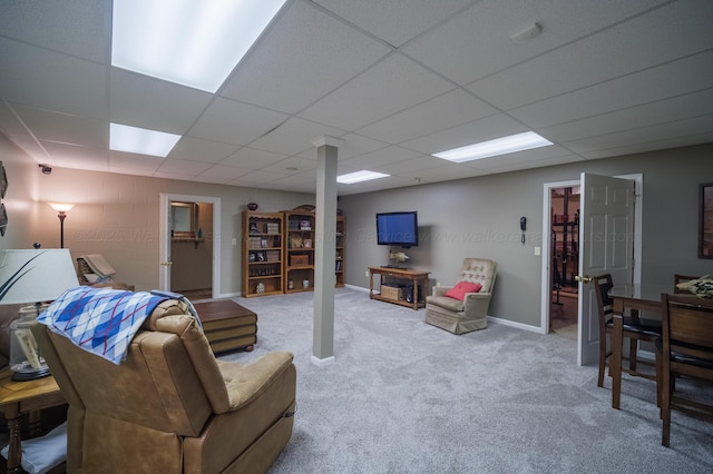 carpeted living room featuring a paneled ceiling