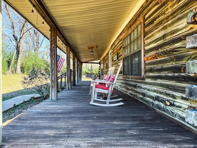 wooden terrace featuring covered porch