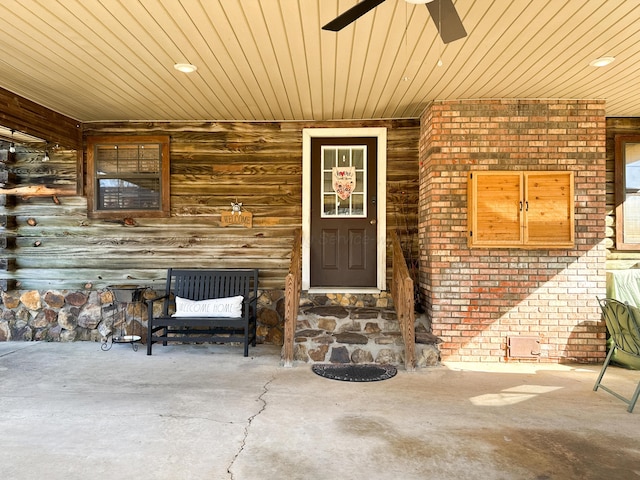 view of exterior entry with ceiling fan