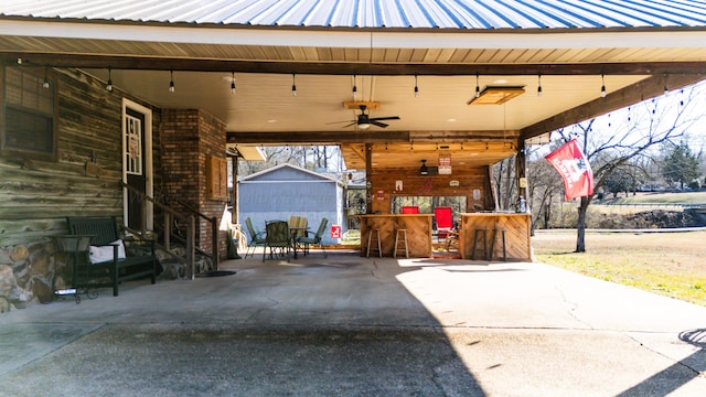 view of patio / terrace with ceiling fan and exterior bar