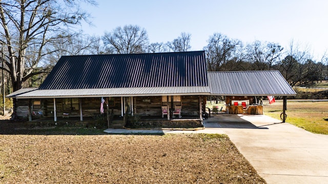 view of front of house featuring covered porch and a carport