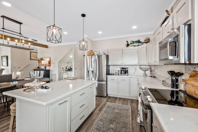 kitchen featuring tasteful backsplash, a center island, pendant lighting, stainless steel appliances, and white cabinets