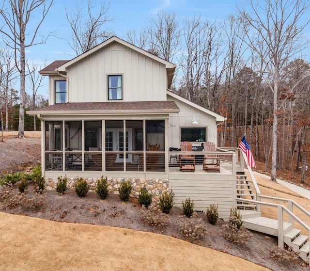 rear view of house featuring a sunroom