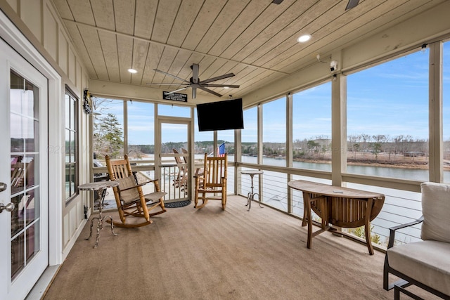 sunroom / solarium with plenty of natural light, wooden ceiling, and ceiling fan