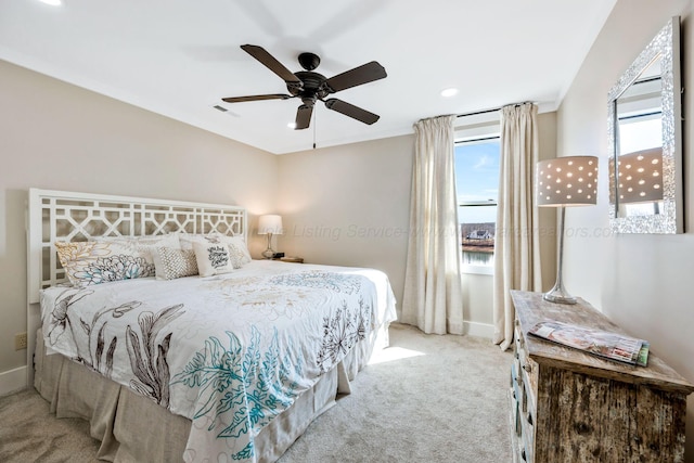 bedroom featuring ceiling fan and light carpet