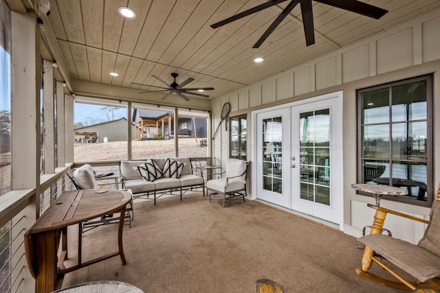 sunroom / solarium with wood ceiling, ceiling fan, and french doors