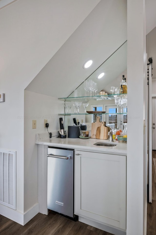 kitchen with dark hardwood / wood-style flooring, sink, lofted ceiling, and dishwasher