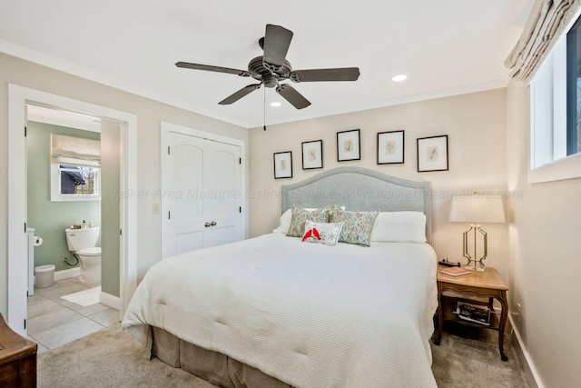 bedroom with ceiling fan, ensuite bath, ornamental molding, and light tile patterned floors