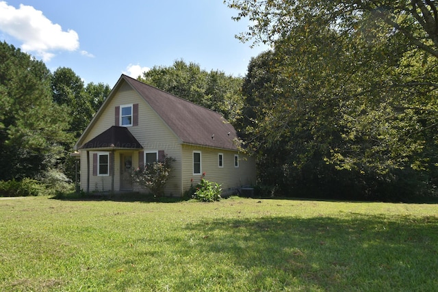 view of home's exterior with a lawn