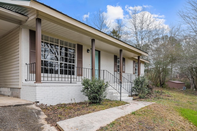 doorway to property featuring covered porch