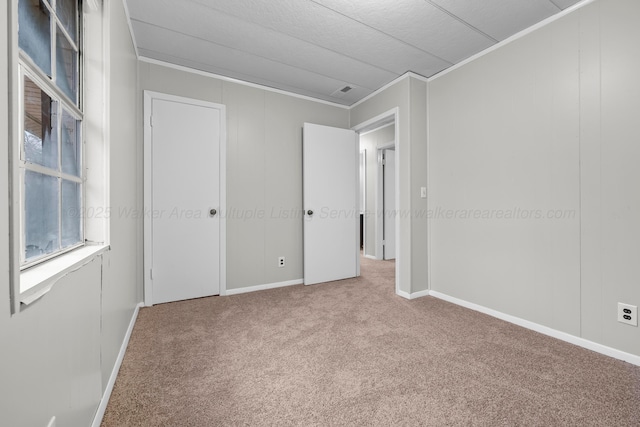 unfurnished bedroom with carpet and ornamental molding