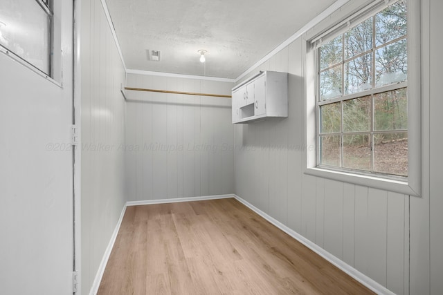 spacious closet with light hardwood / wood-style flooring