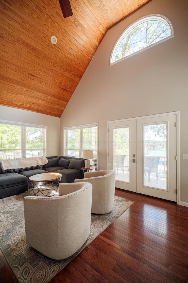 living room with a wealth of natural light, hardwood / wood-style floors, and high vaulted ceiling