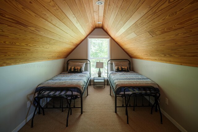 carpeted bedroom with wood ceiling and vaulted ceiling