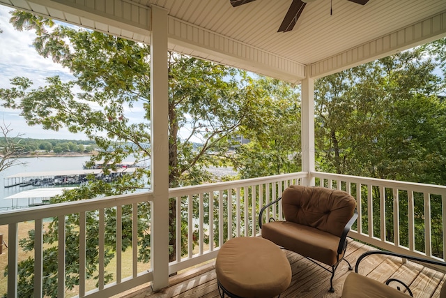 wooden deck featuring ceiling fan and a water view