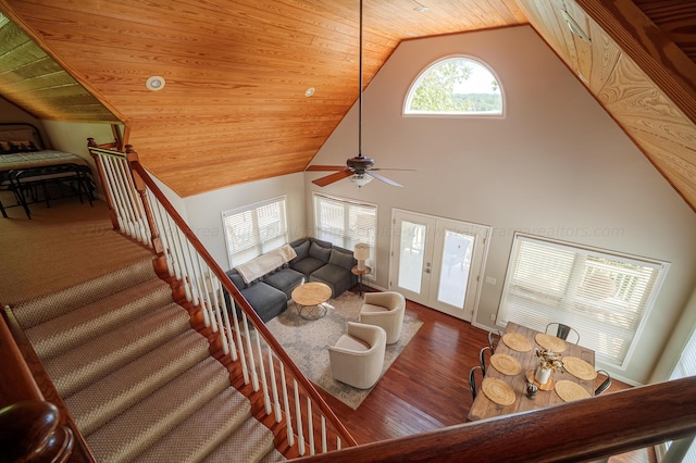 living room featuring high vaulted ceiling, french doors, hardwood / wood-style flooring, ceiling fan, and wood ceiling