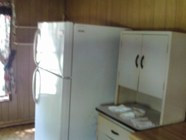 kitchen featuring white cabinetry and white refrigerator