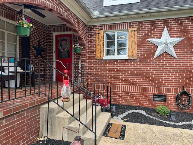 view of exterior entry with ceiling fan