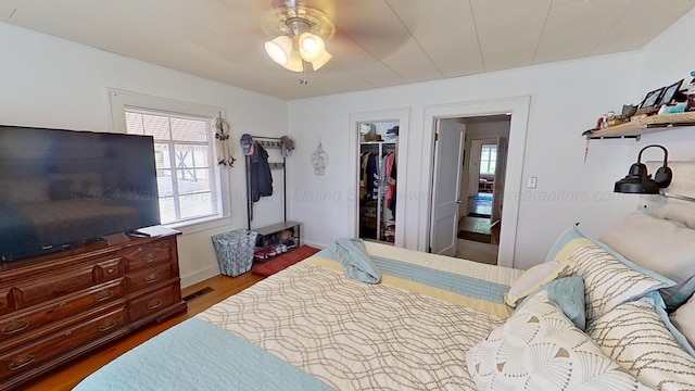 bedroom with ceiling fan, wood-type flooring, and a closet