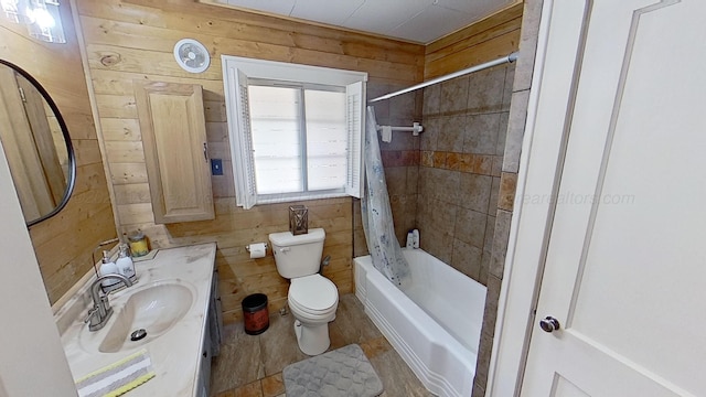 full bathroom featuring wood walls, vanity, shower / tub combo, and toilet