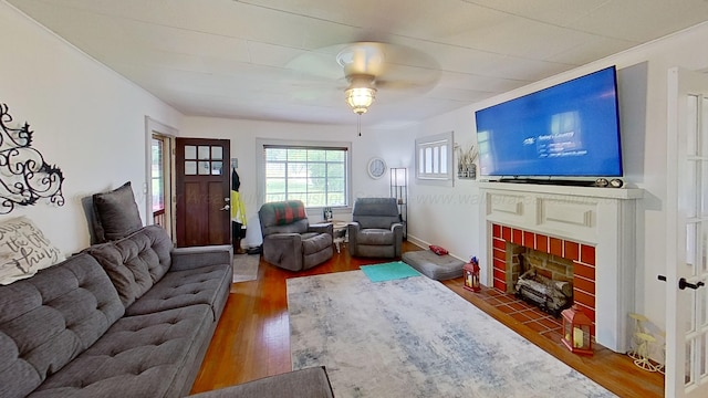 living room featuring a fireplace, hardwood / wood-style flooring, and ceiling fan