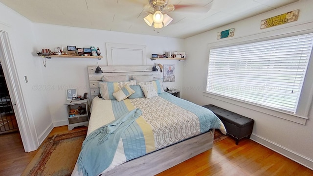 bedroom featuring hardwood / wood-style floors and ceiling fan