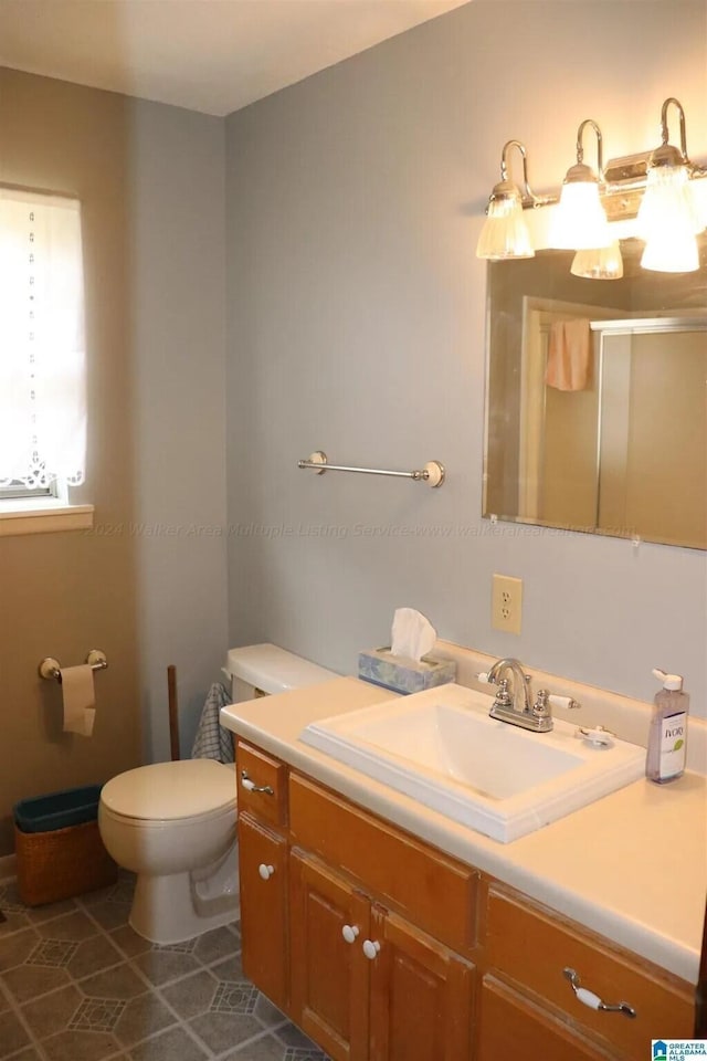 bathroom with tile patterned flooring, vanity, and toilet